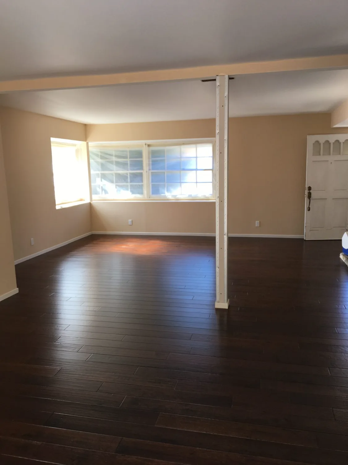 Dark hardwood flooring in an empty living room