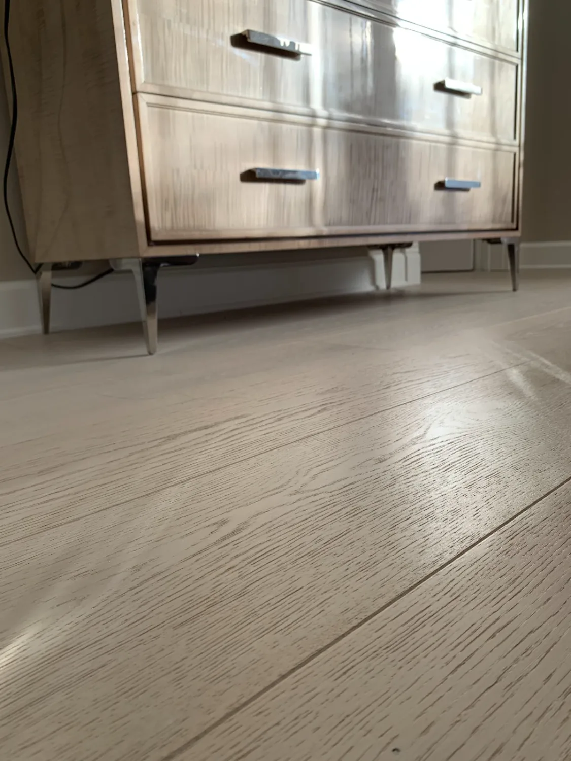Light engineered hardwood flooring in a bedroom
