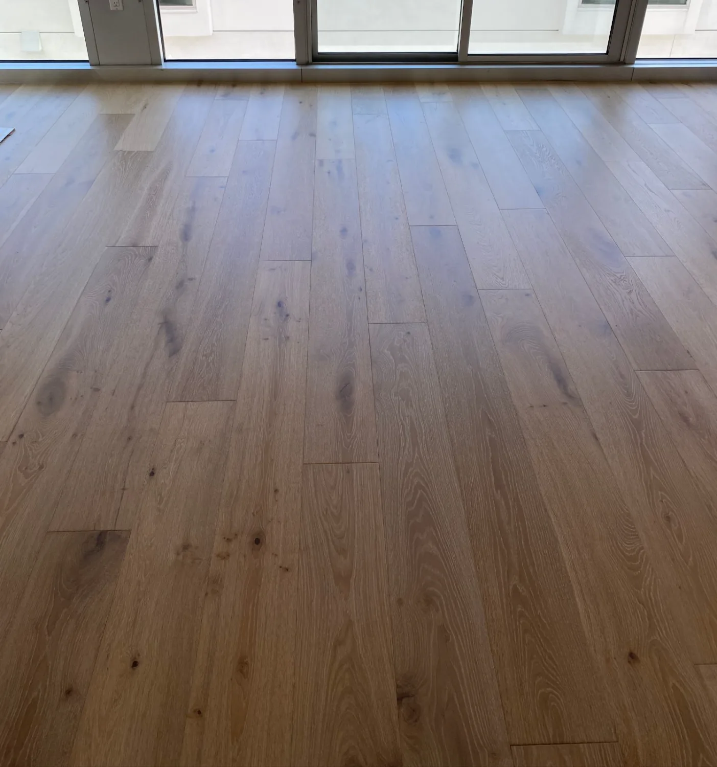 Greige oak hardwood flooring in a condo