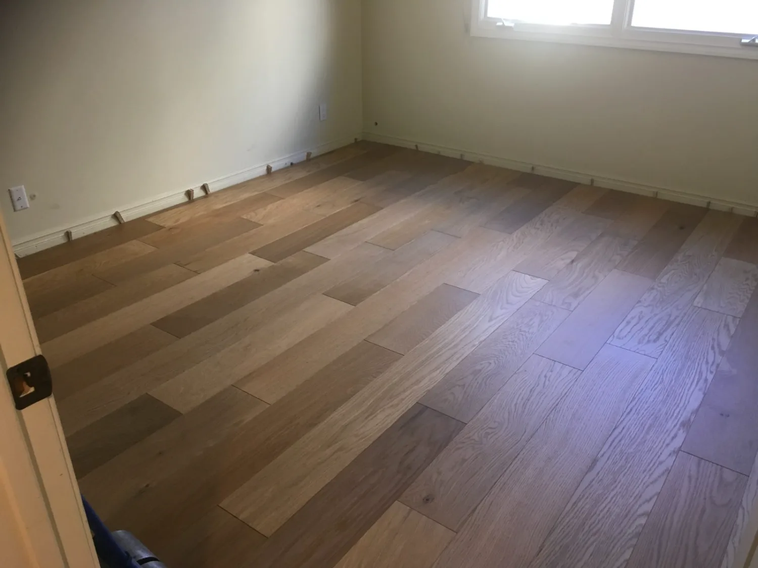 Greige oak hardwood flooring in an empty room