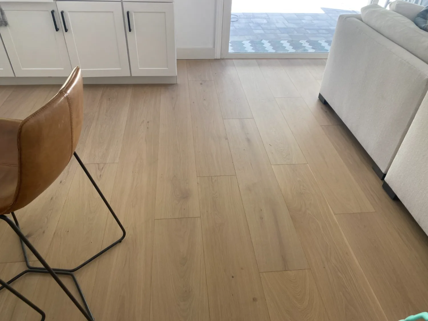 Light oak hardwood flooring in a furnished open living room