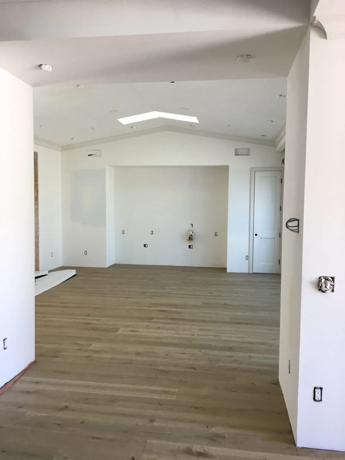 Light oak hardwood flooring in an open vaulted room