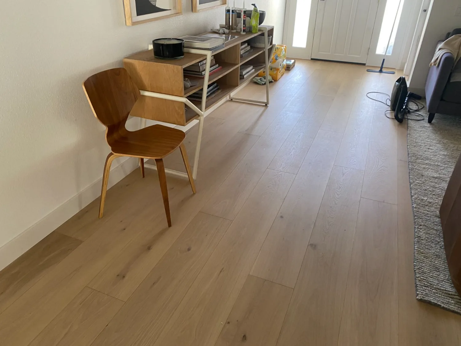 Light oak hardwood flooring in a styled living room with mid-century furniture