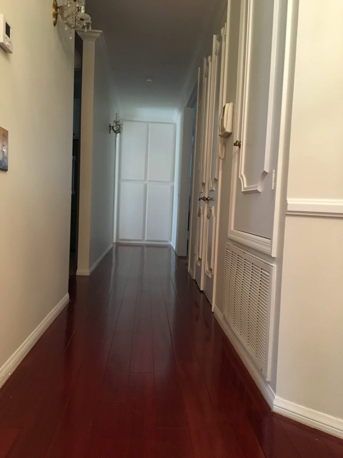 Mahogany-toned hardwood flooring in a hallway