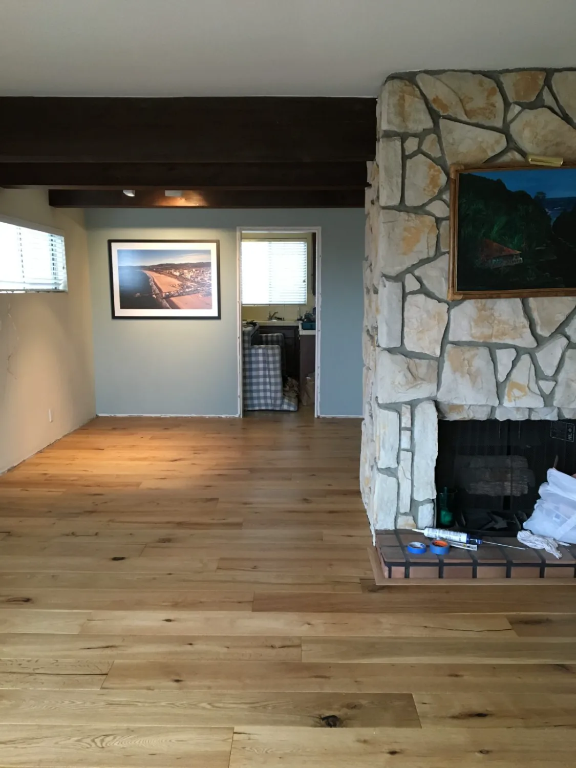 Natural oak hardwood flooring by a stone fireplace