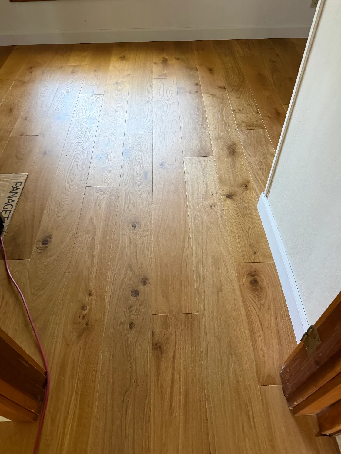 Panaget natural French oak hardwood flooring installed in a bedroom
