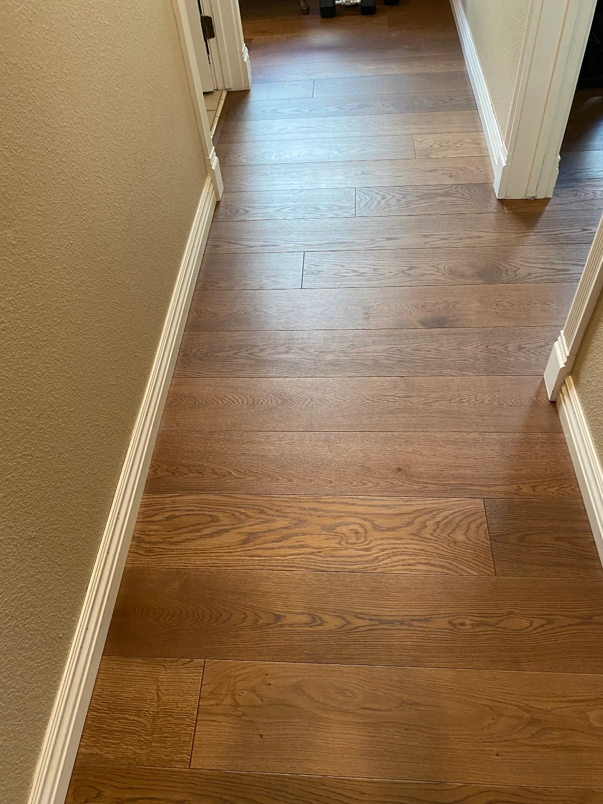 Red oak hardwood flooring running the length of a hallway