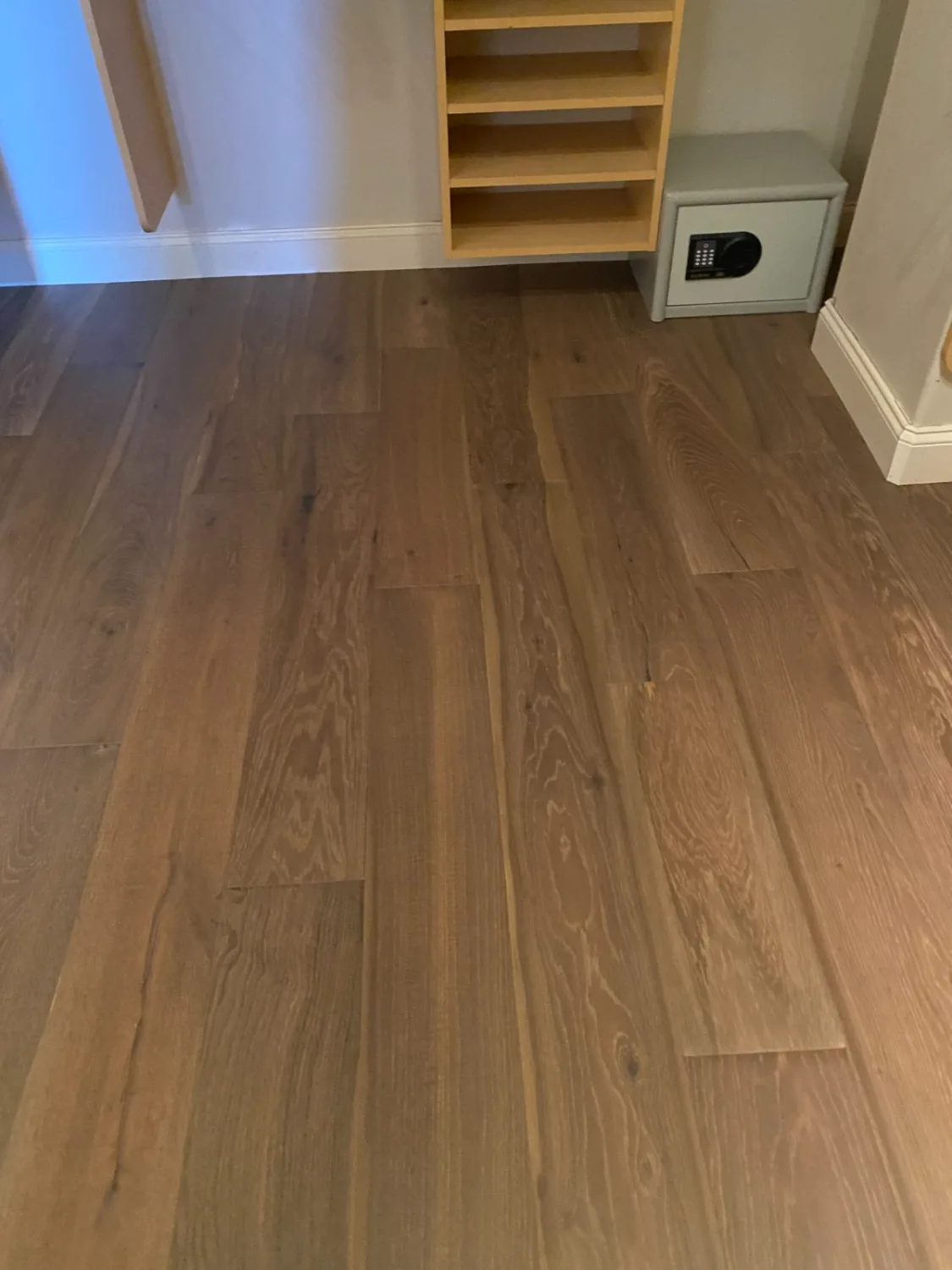 White oak hardwood flooring in a furnished dining room with large windows