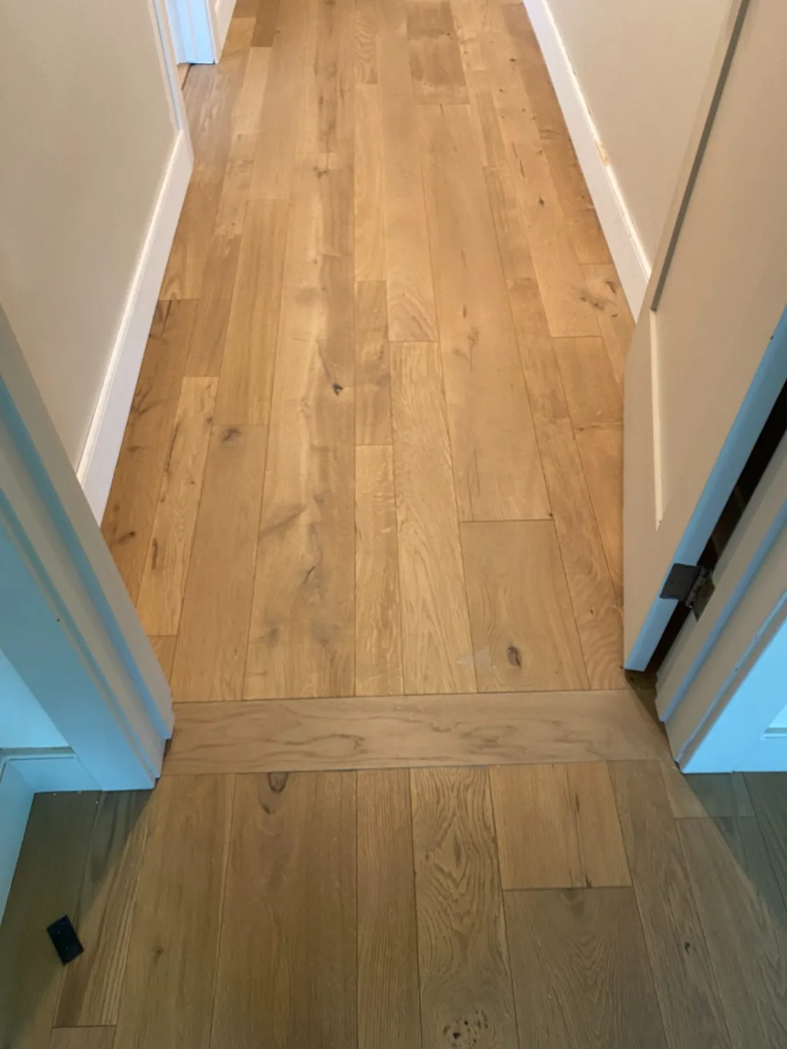 White oak hardwood flooring at a hallway room transition