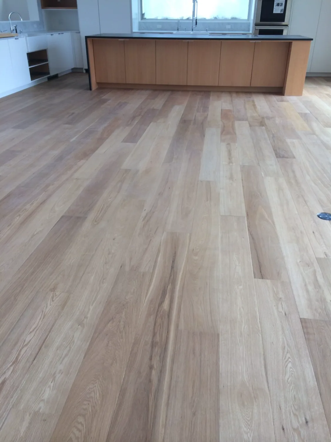White oak hardwood flooring around a kitchen island