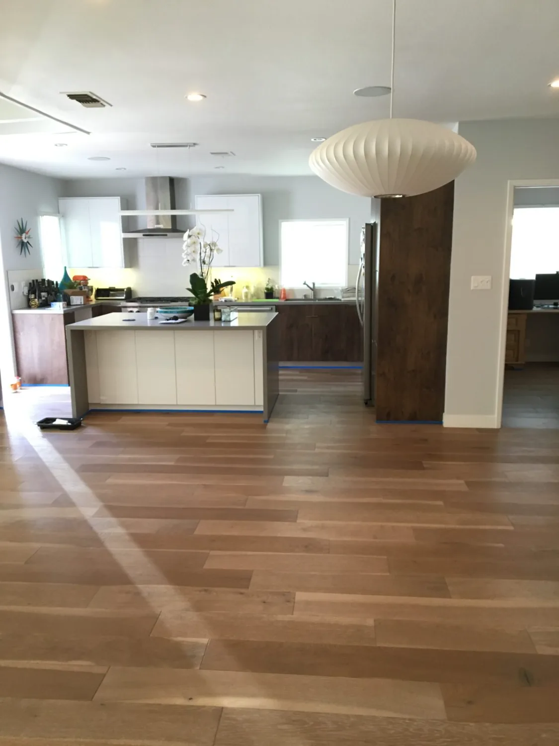 White oak hardwood flooring in an open kitchen and living area