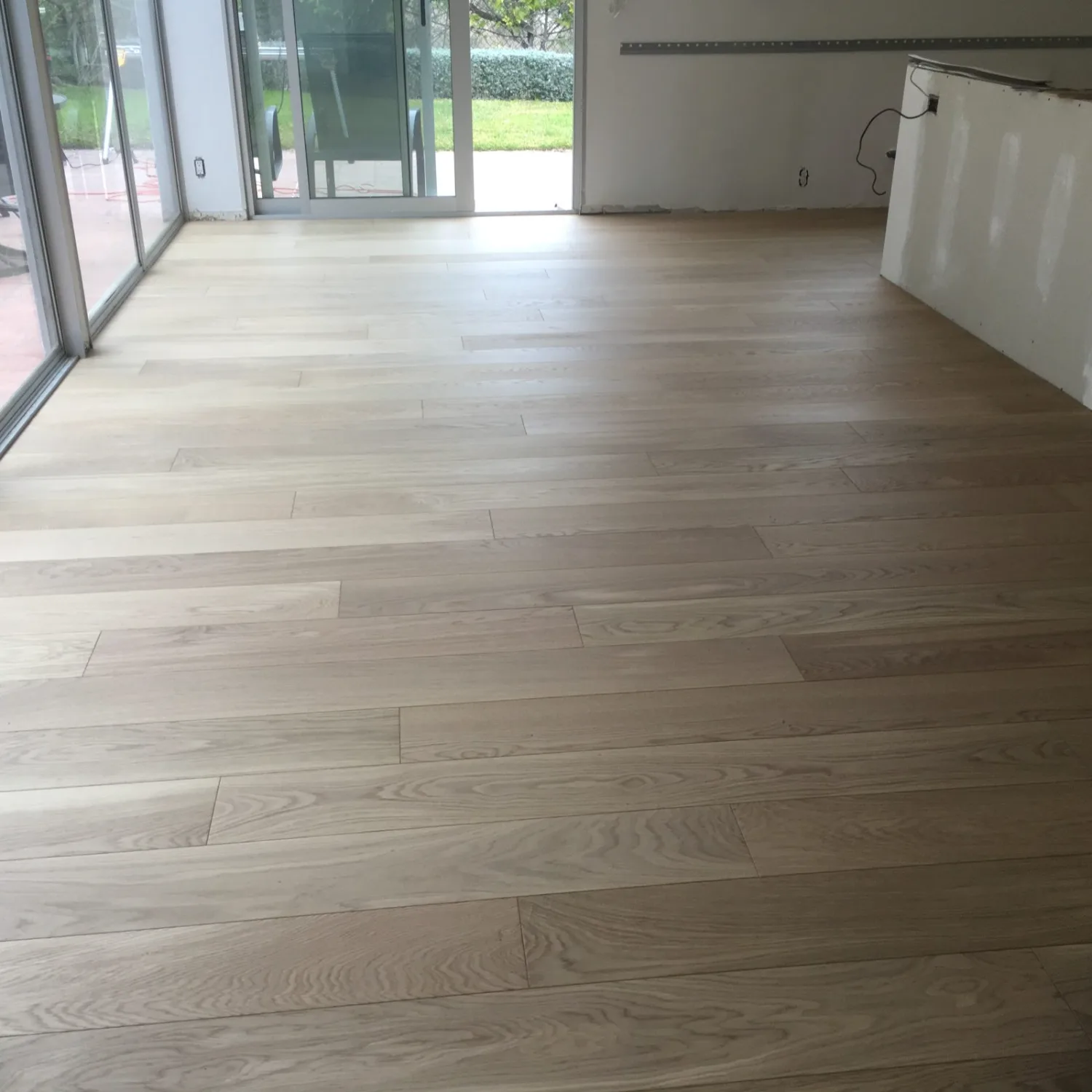 White oak hardwood flooring by sliding patio doors