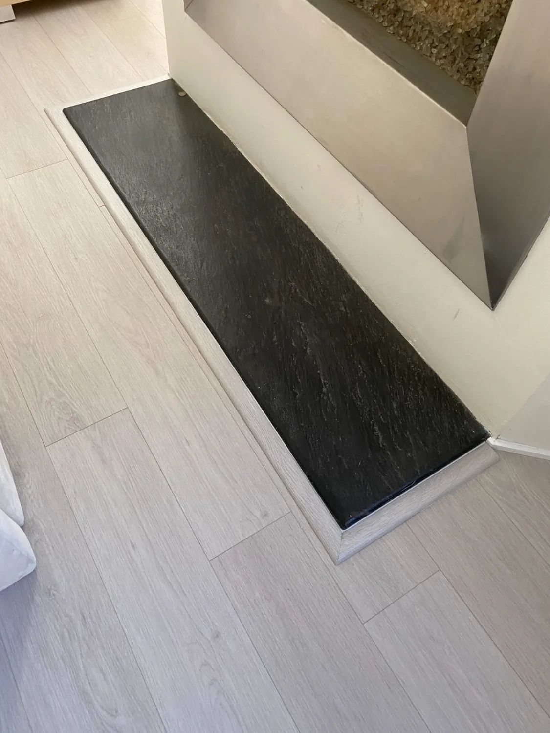 White oak hardwood flooring with a black slate inlay