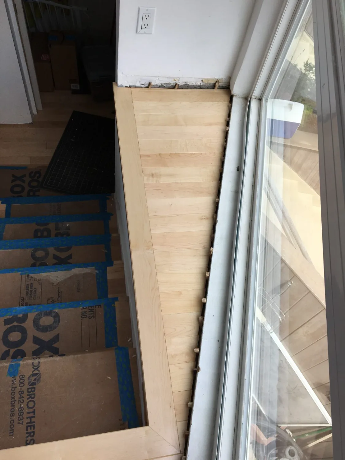 White oak hardwood flooring repair at a doorway threshold