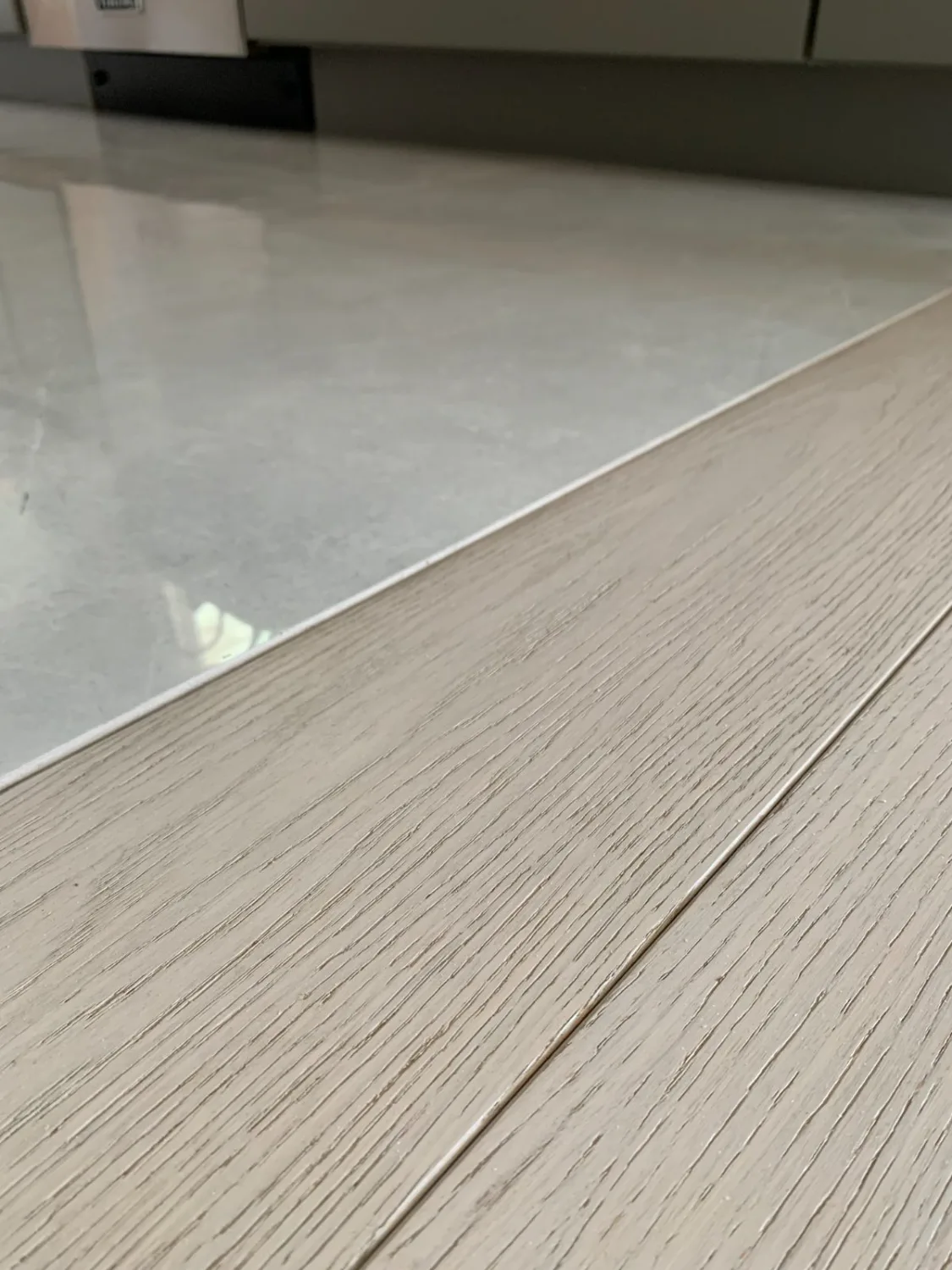 Hardwood flooring patched at a tile transition