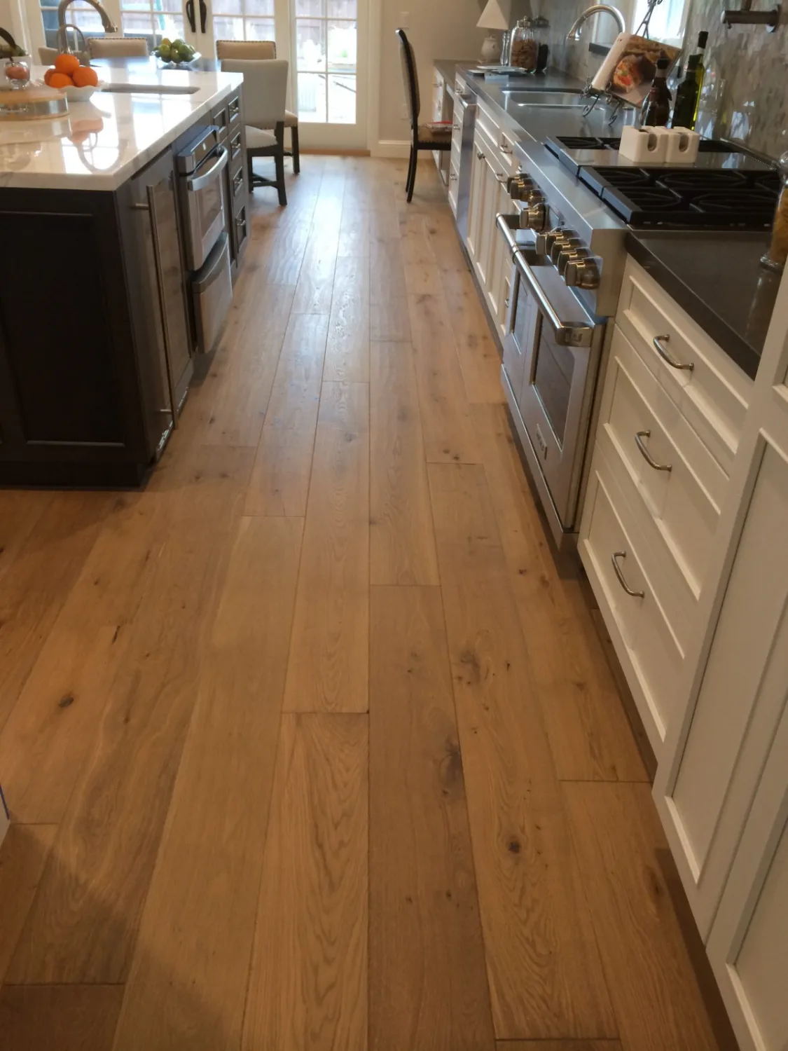 Wide-plank oak hardwood flooring in a kitchen