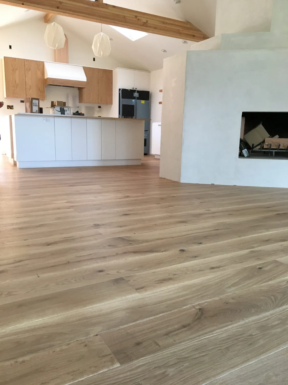 Wide-plank oak hardwood flooring in an open living room