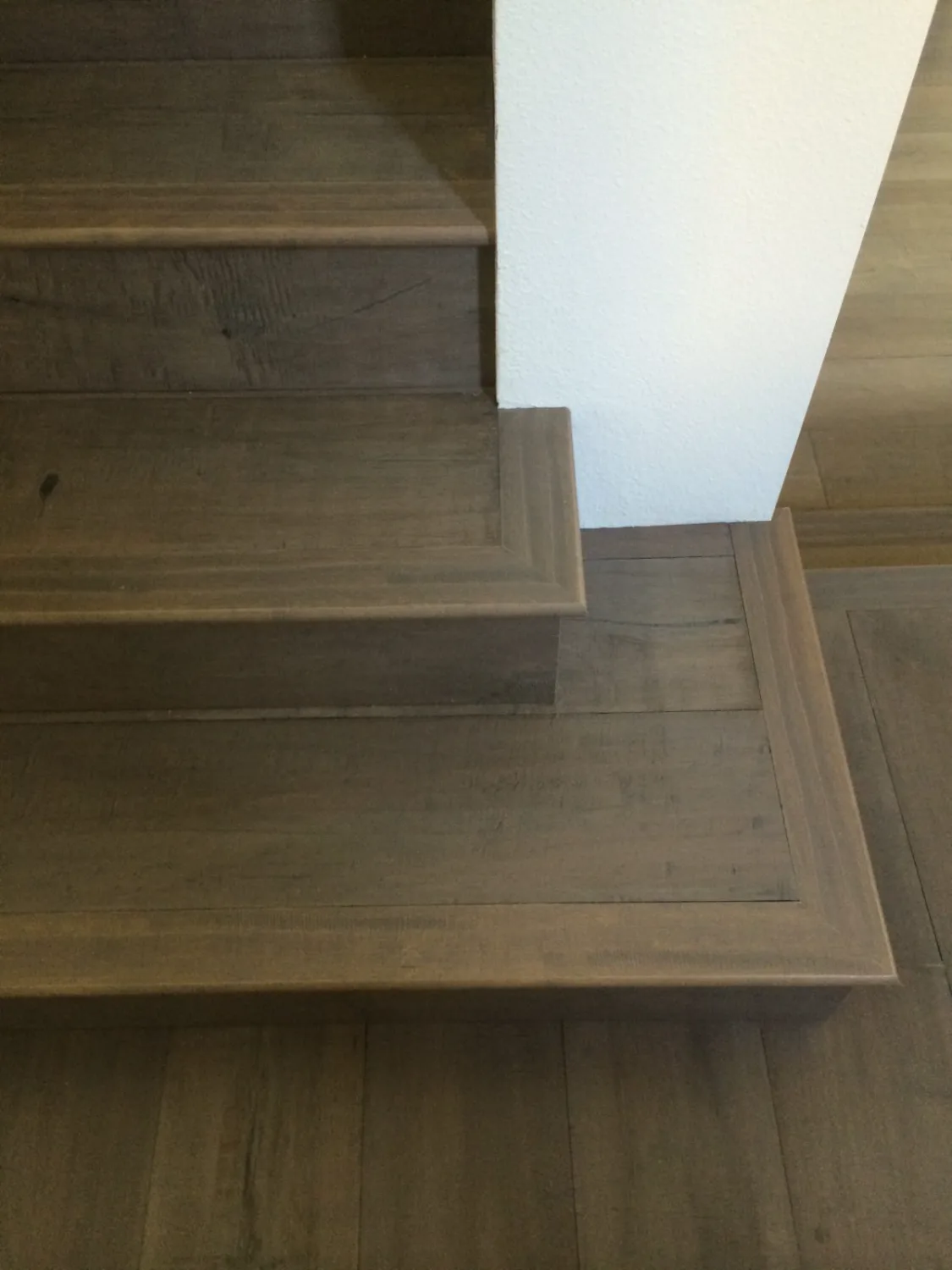 Gray hardwood step with mitered nosing