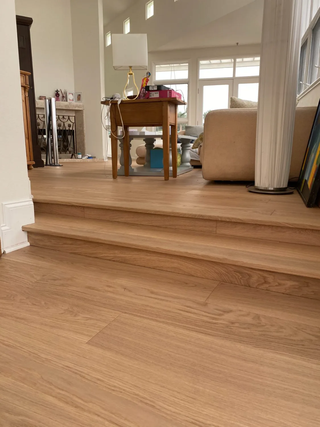 Oak hardwood stairs leading into a living room