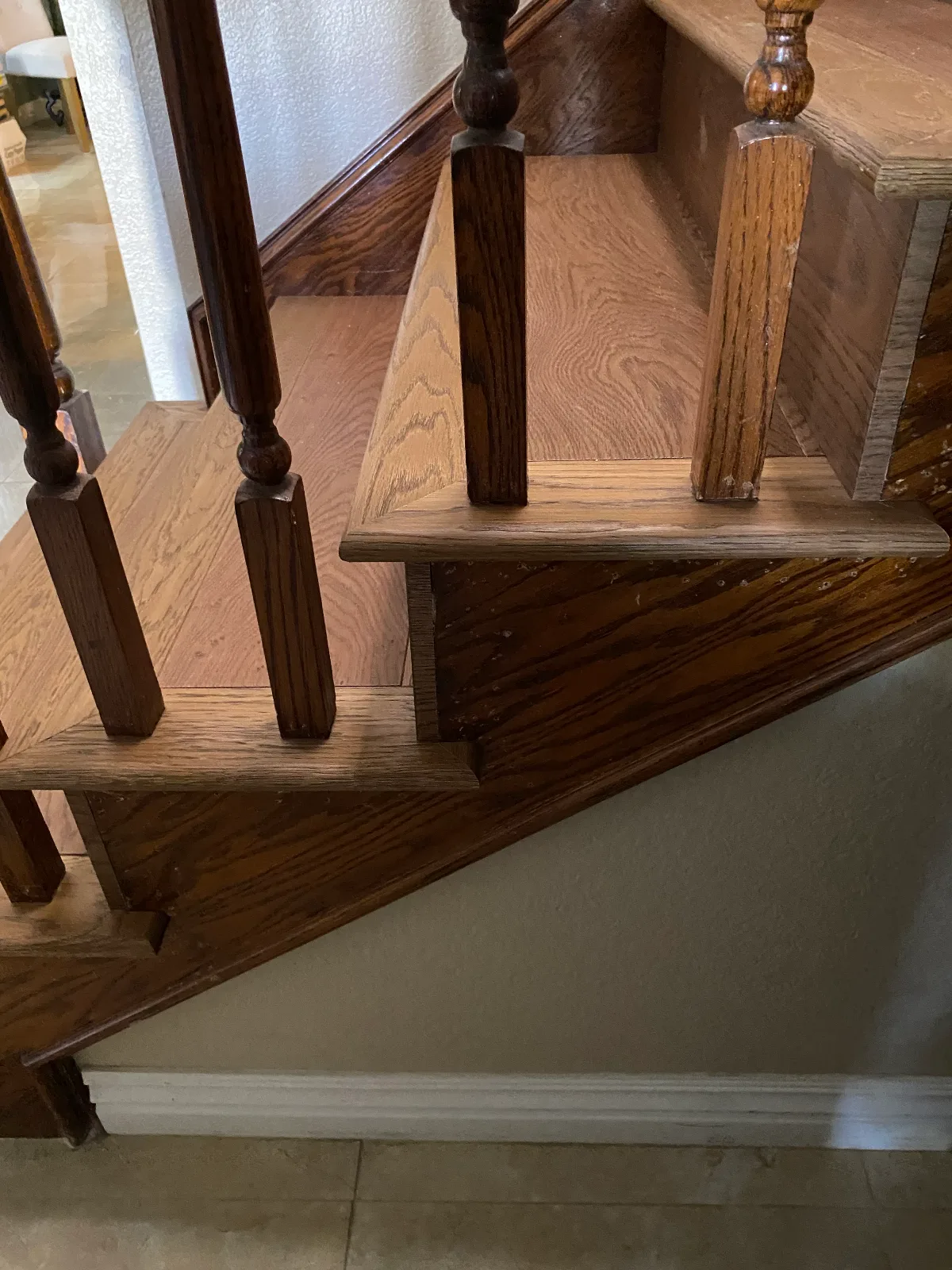 Red oak winder tread and newel post detail on a hardwood staircase