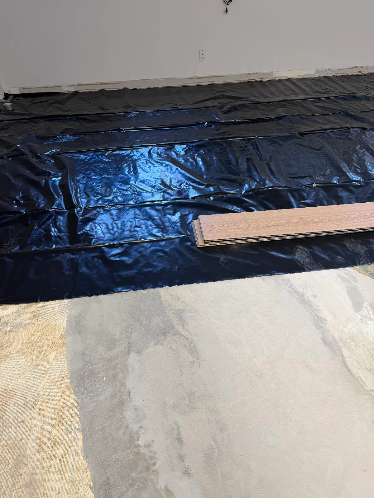 Self-leveling compound over a concrete slab ahead of SPC vinyl plank