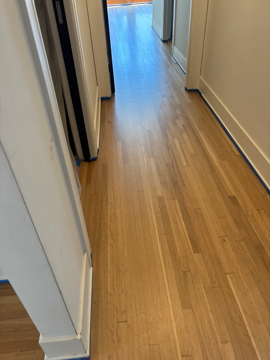 Red oak hardwood floor refinished to a natural finish in a hallway