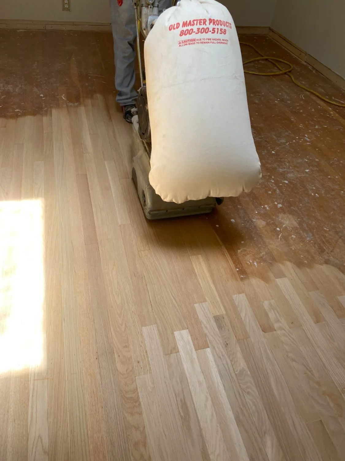 Refinishing a red oak hardwood floor with a drum sander